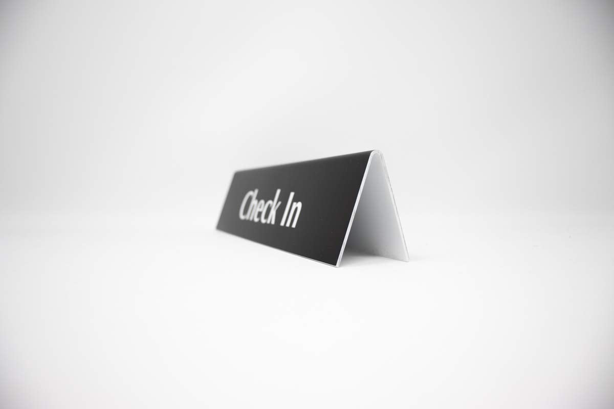 Check In Sign | Reception Desk & Lobby Counter Signs | Waiting Room Signage | Laser Engraved & Double Sided | 9” x 2” Black Acrylic | Made In USA
