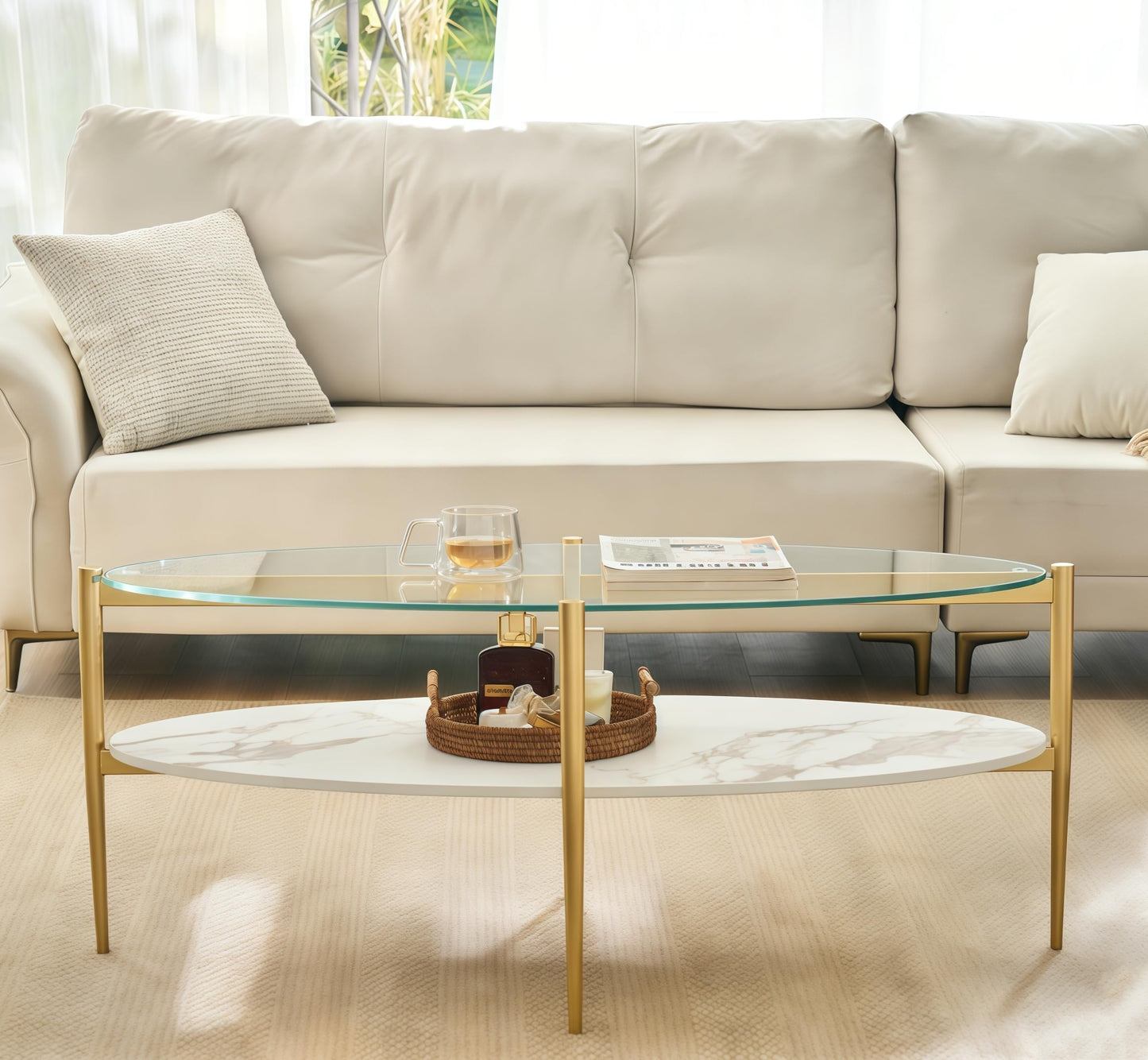 Shrine Oval Coffee Table, Mid-Century Modern Design, 2-Tier Structure, Clear Glass Top and White MDF Shelf, 47" D x 21" W x 17" H, Sleek Conical Metal Legs with Gold Finish